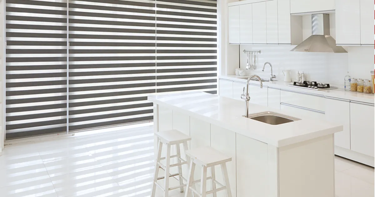 Grey combi blinds across the windows of a white kitchen